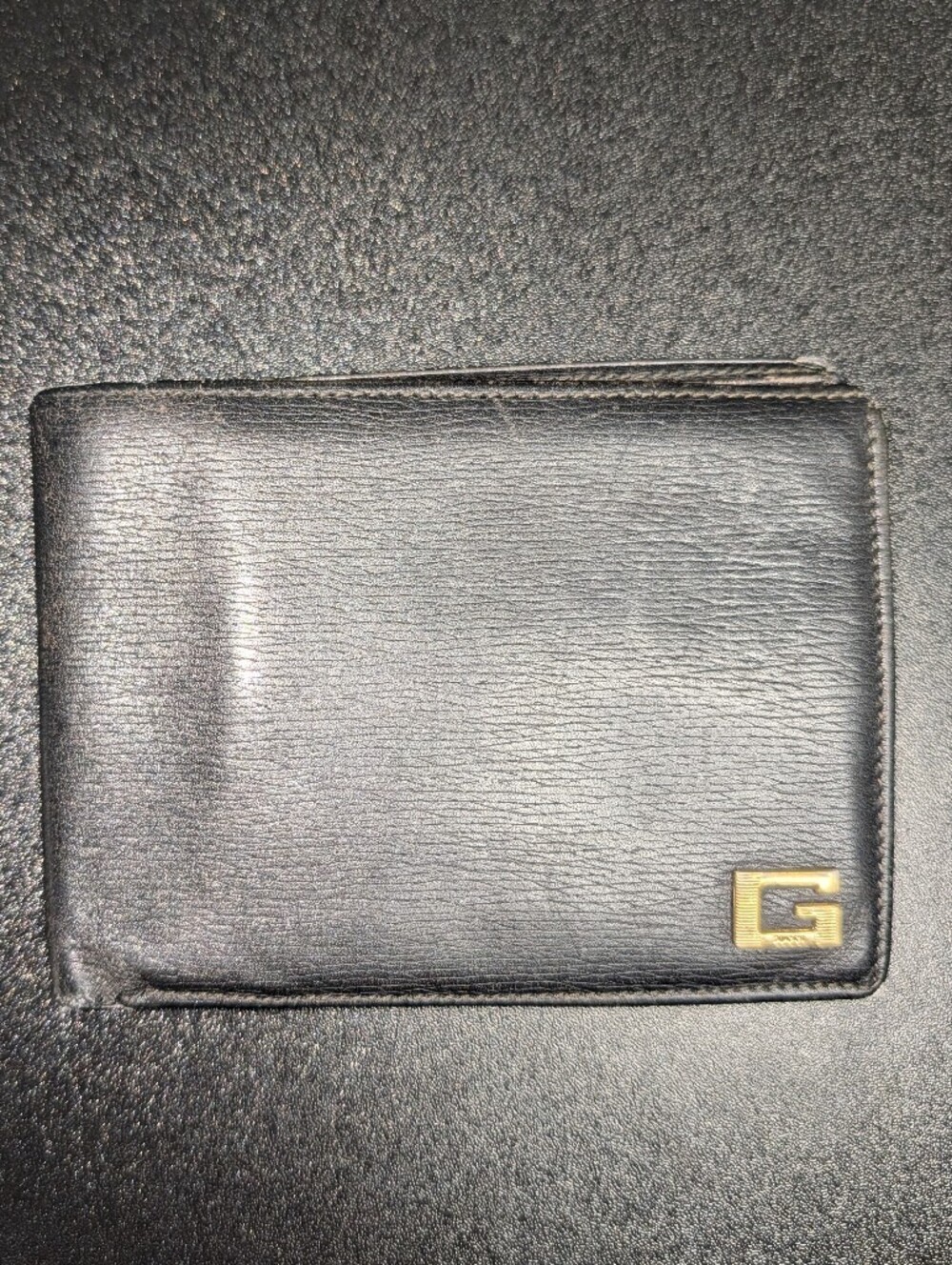 Low Start Gucci Men's Black Leather Bi-Fold Wallet with Gold Accent